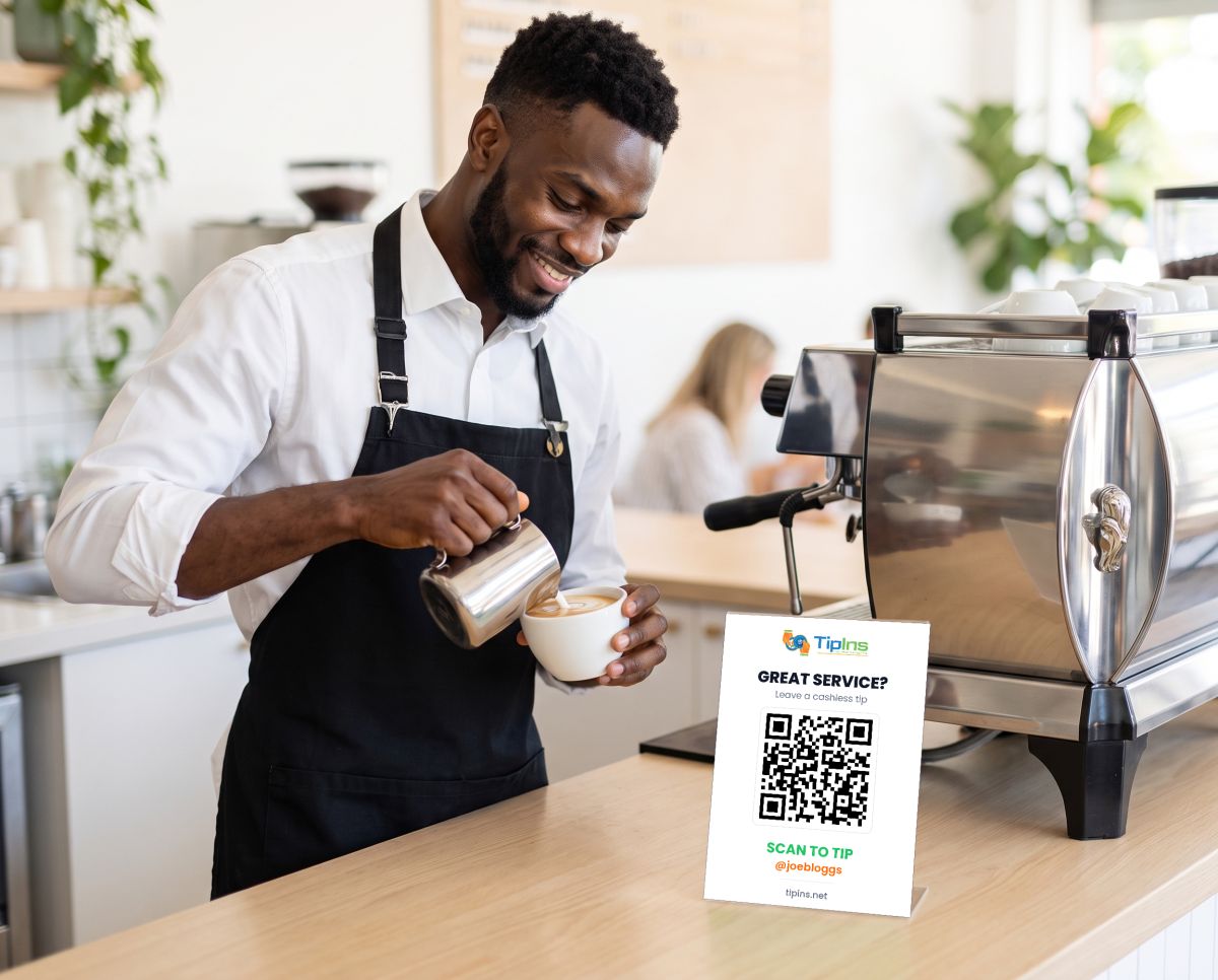 Joe pouring latte art with his TipIns QR sign on the counter