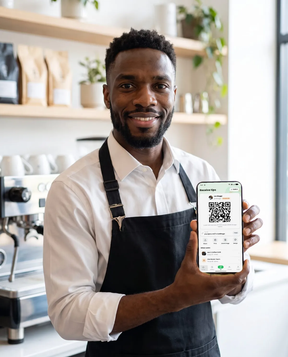 A cafe worker holding a phone that shows a QR code for tips